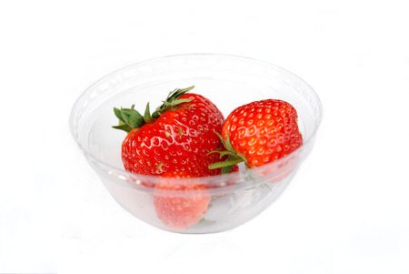 Strawberry pretty red berries in glass with white backgroundの写真素材