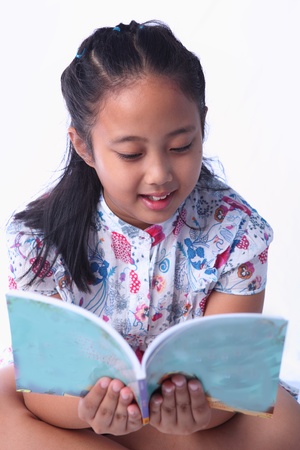 girl reading a book isolatedの写真素材