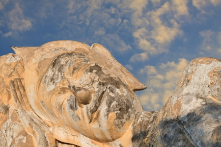 face of buddha statue and blue skyの写真素材