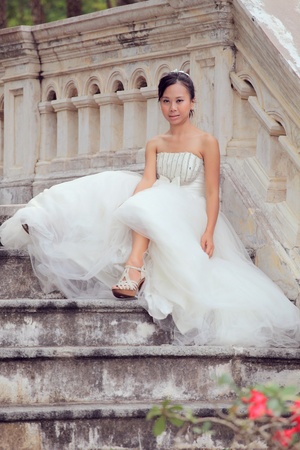 women in white bride sitting on stairwayの写真素材