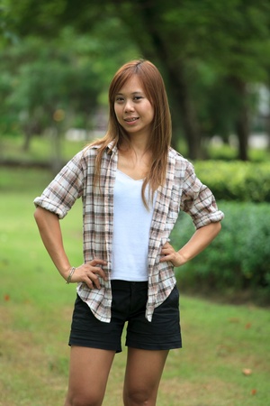 asian women post for take a photo in the parkの写真素材