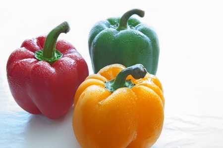 red green yellow paprika chilly on white backgroundの写真素材