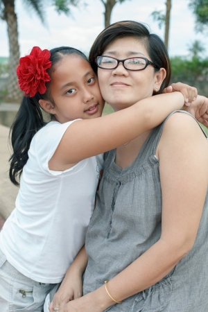 asian girl hug on motherの写真素材