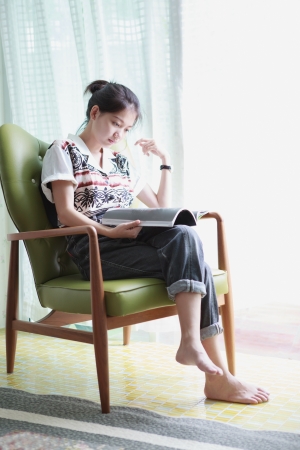 woman reading a book at homeの写真素材