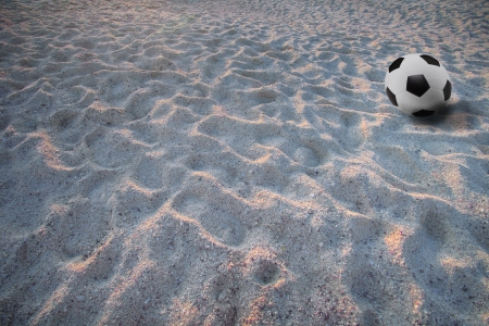 soccer football on sand beachの写真素材