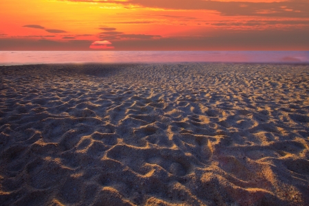 sun set and sand beach with rim lightの写真素材