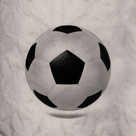 black and white soccer football on wrinkled paper textureの写真素材