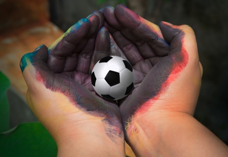 soccer football in painted hand with colorの写真素材