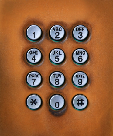 dial number button on old used public telephone の写真素材