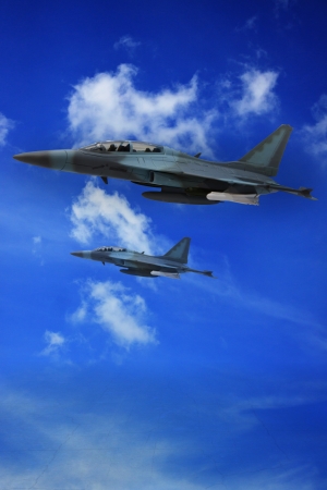 milliary air plane flying on blue sky and land ground belowの写真素材