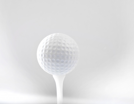 golf ball on tee and grey space backgroundの写真素材