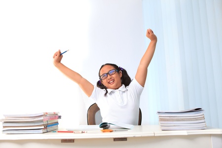 girl lift her hand in class roomの写真素材