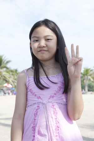 face of asian girl show finger acting as a symbolic of number の写真素材