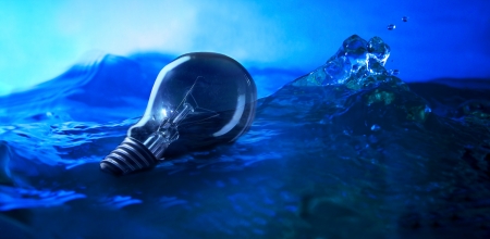 light bulb floating on sea with wind stormの写真素材