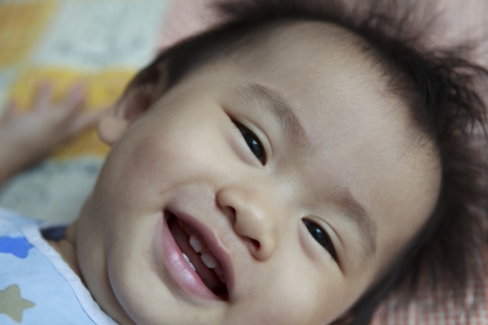 asian baby show four teeth in mouthの写真素材