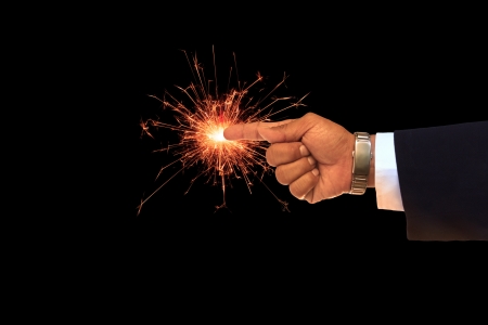 business man hand pointing on sparking fireの写真素材