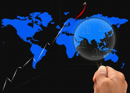 hand and magnifying lens watching on graph map around asiaの写真素材