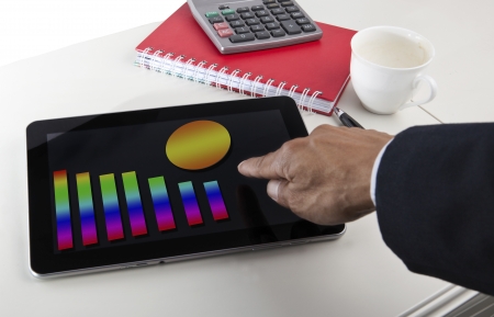 business graph report on  tablet screen monitor on working tableの写真素材