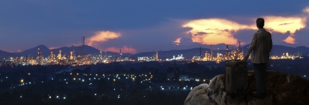 invester with big bag standing on the rock and looking to industry city use for people and investment topicの写真素材