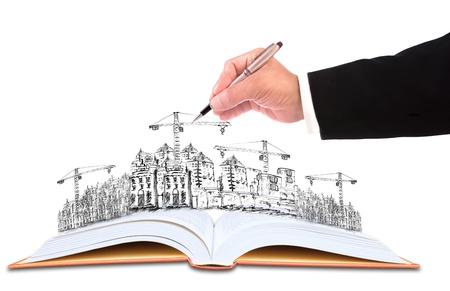 hand of businessman writing on sketching of  building construction for construction business themeの写真素材