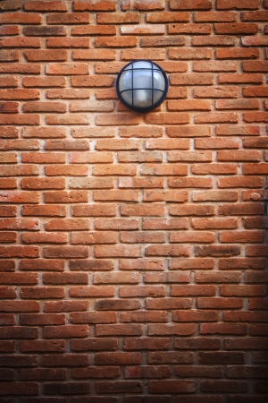 red brick wall and light lamp use for multipurposeの写真素材