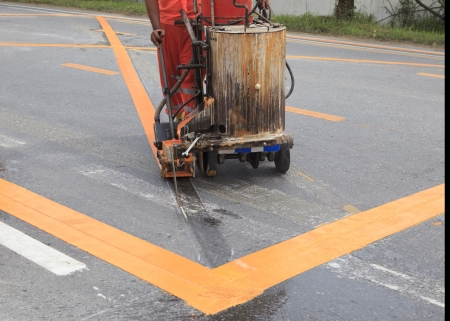 machine and worker at road construction use for road and traffic sign painting の写真素材