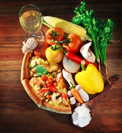 mixed contain and vegatable with  pieces of sea food pizza on wood table の写真素材