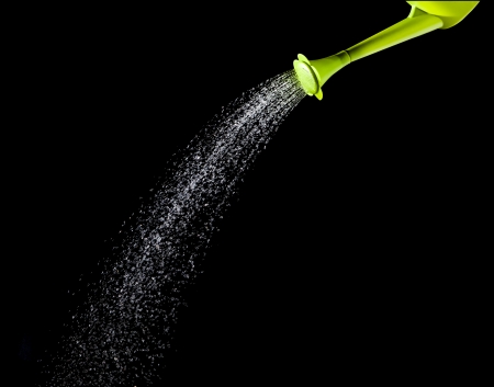 green watering can pouring waterの写真素材