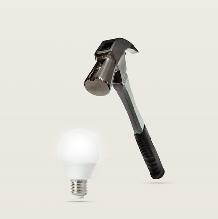 abstract of heavy metal hammer and led light bulbの写真素材