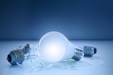 abstract of led light bulb glowing and lyinjg with another broken bulb use for idea and creative symbolの写真素材