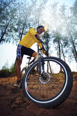 young man riding mountain bike mtb in jungle track use for sport extreme adventure healthy and holiday activities life style の写真素材