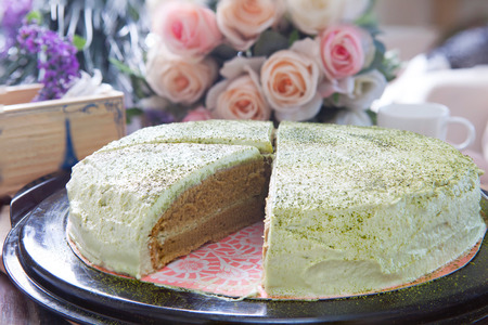 close up big pound of green tea cake sliced on table top