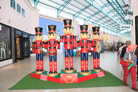 PETCHABURI THAILAND OCT11- wood soldier toy in red uniform standing decorated in front of The Venezia Huahin european style shopping mall at  phetkasem rd. southern high way of thailand on october 11,2014 in petchaburi thailandのeditorial素材