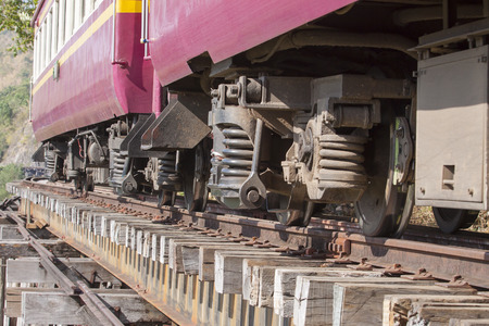 lower view of trainst suspension on old wood railways bridge