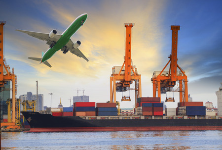 ship on port and cargo flying aboveの写真素材