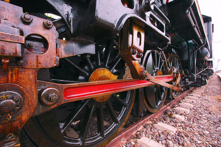 iron wheels of stream engine locomotive train on railways track perspective to golden light forward...