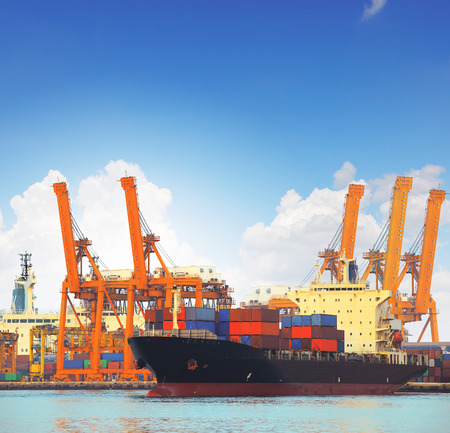 commercial ship and cargo container on port use for import export and freight logistic water transport industryの写真素材