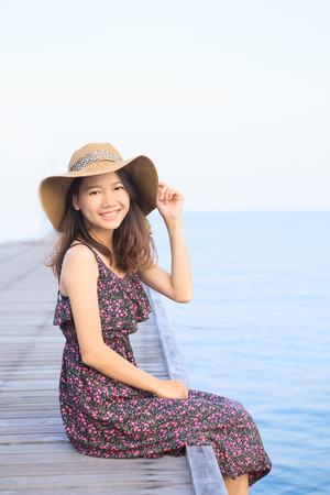 portrait of beautiful woman wearing long dress and straw hatの写真素材