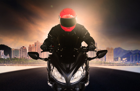 close up rider man wearing safety suit and anti knock helmet riding big bike motorcycle on asphalt...