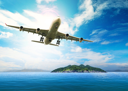 passenger plane flying over beautiful blue ocean and island in purity destination sea beach use for summer holiday vacation treveling passenger plane flying over beautiful blue ocean and island in purity destination sea beach use for summer holiday vacation treveling