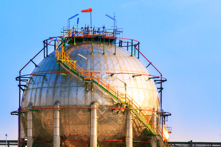 natural petrochemical gas storage tank in heavy petroleum industry estate against clear blue sky backgroundの写真素材
