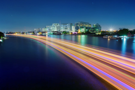 light of boat running in river painting beautiful light in chao phraya river with sirirach hospital one of important bangkok landmark of thailandの写真素材