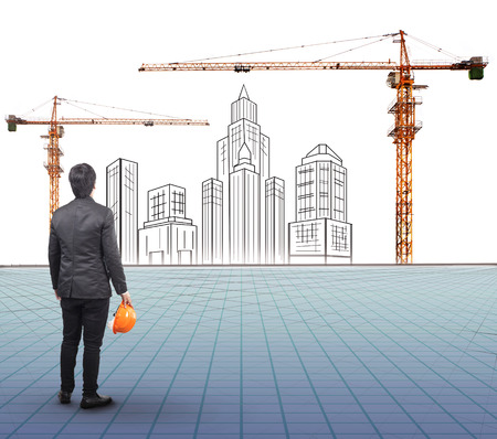 engineering man holding safety helmet standing in front of  modern building sketching with  crane construction siteの写真素材