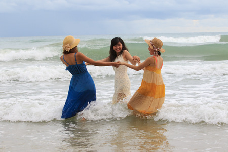 portrait group of young asian woman playing with happiness emotion on vacation sea beach use for people lifestyle activities leisure on traveling sea destinationの写真素材