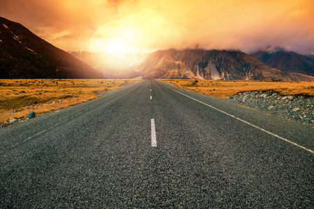 beautiful land scape of asphalt highways perspective to sun set mountain use for multipurpose natural backgroundの写真素材