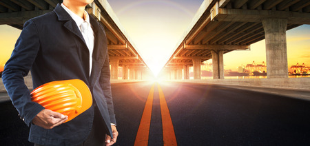 sun rising behind perspective on bridge ram construction and asphalt raod perspective to ship port...