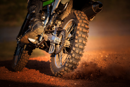 action of enduro motorcycle on dirt trackの写真素材