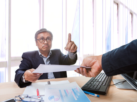 angry business man  return paper project working to under working man with commanding fingerの写真素材