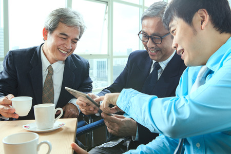 relaxing emotion of business man in coffee break time with younger and senior working friend relationの写真素材