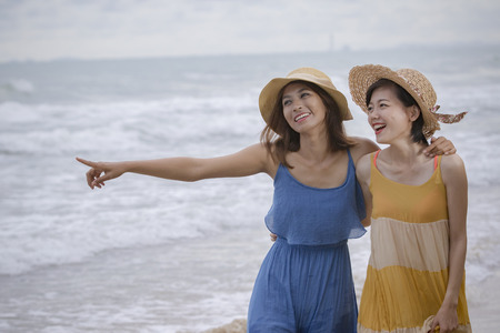 young asian woman friend relaxing emotion at sea beach summer vacation timeの写真素材